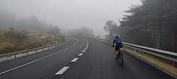 Carretera sinuosa mientras arranca la niebla en el Puerto de El León, Guadarrama